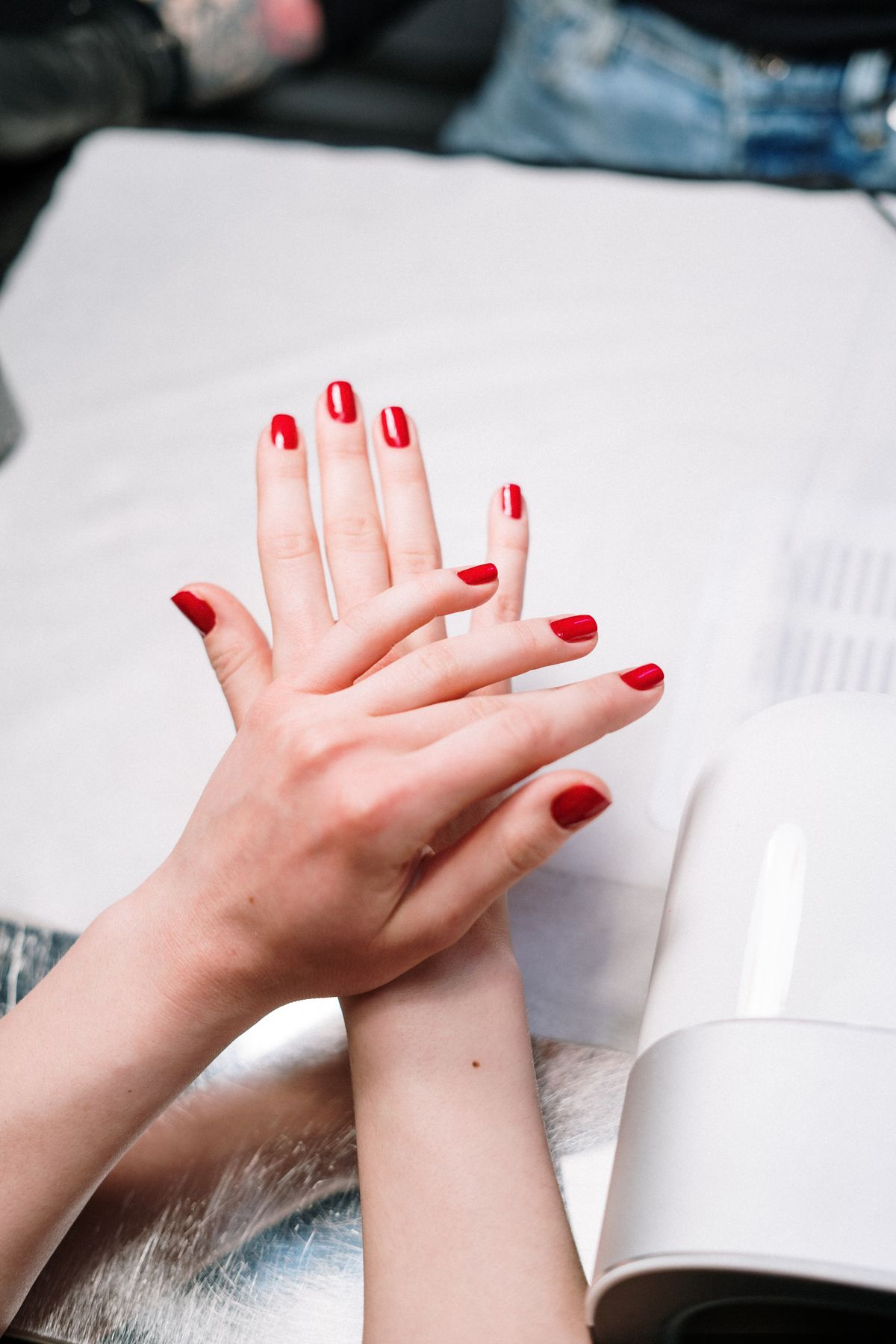 Gel manicure curing under UV lamp at Sphere Nails Bar